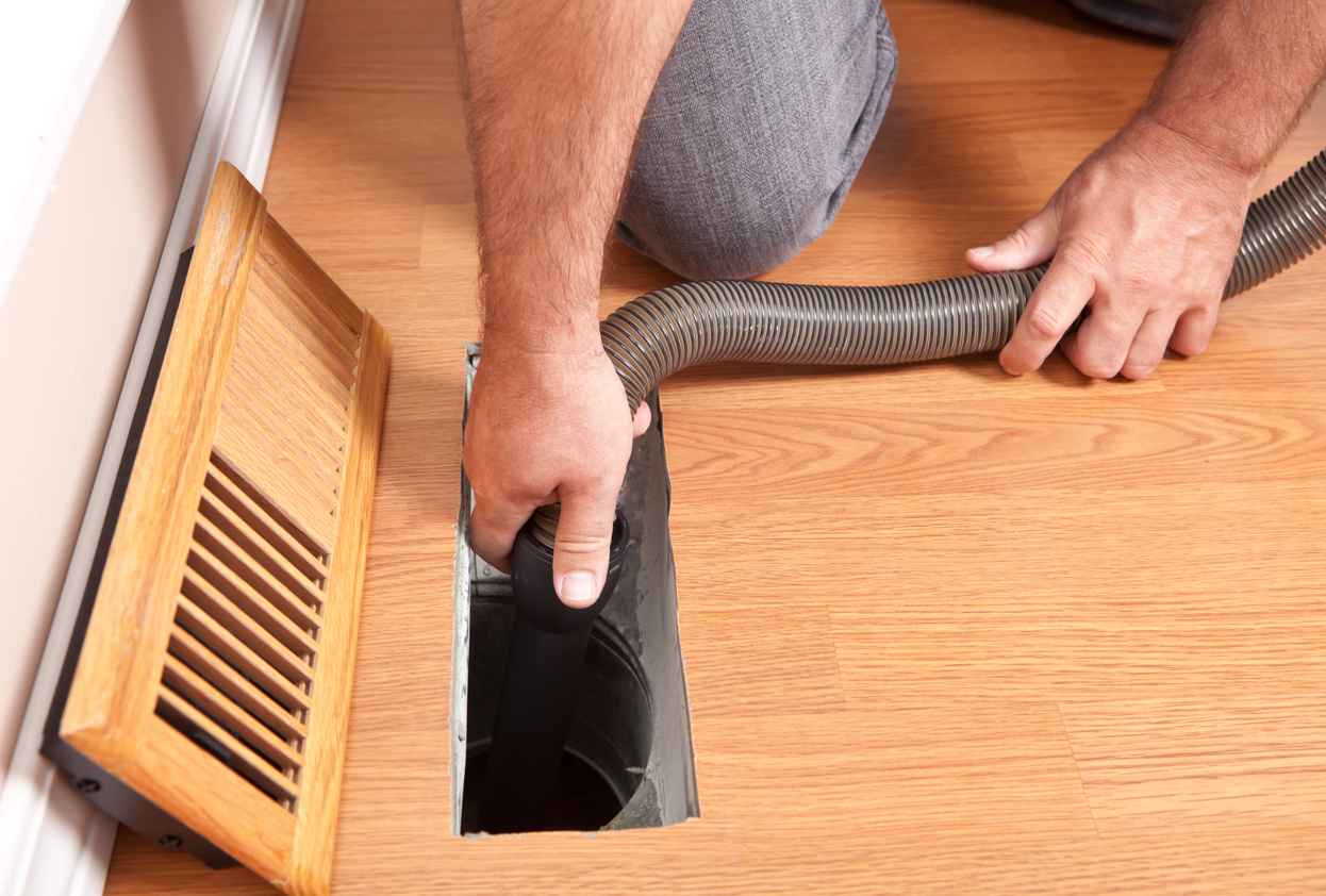 Homeowner cleaning their air ducts