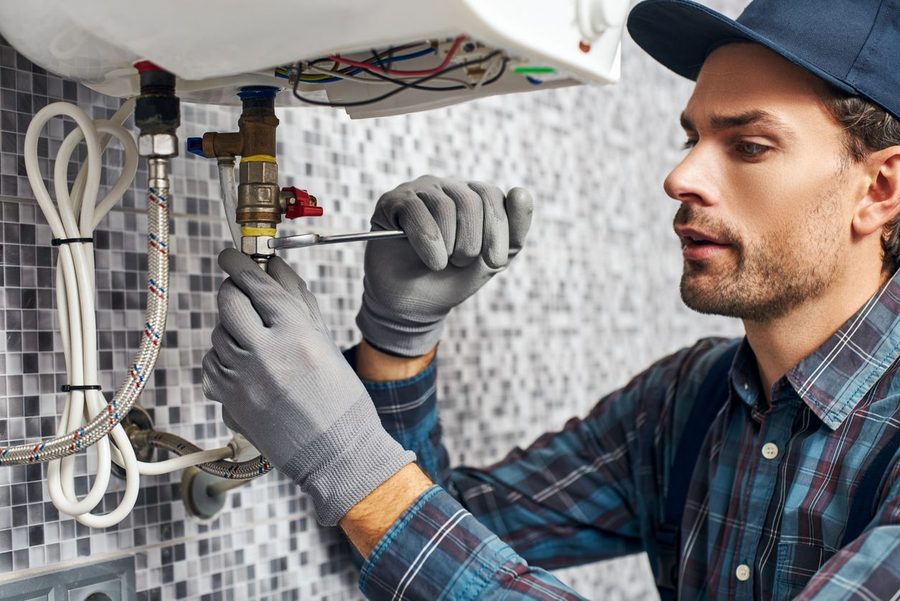 Plumber in a commercial bathroom