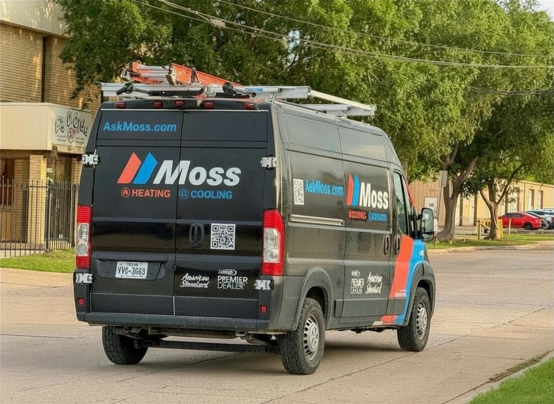 Black Moss Heating & Cooling service van with ladder rack on a street, showing logos, URL, and QR code on the side and back doors.