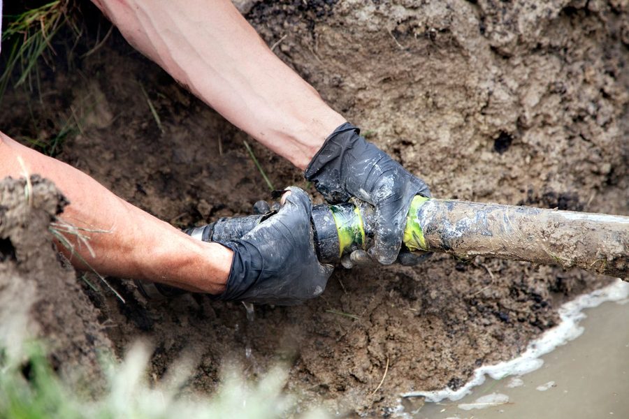 Plumber Repairing a Broken Pipe