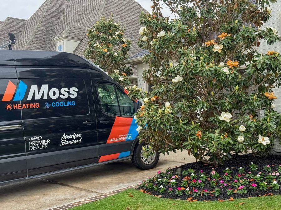 Moss work truck in the driveway of home