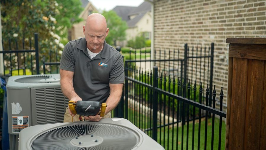 Moss technician checking an HVAC unit