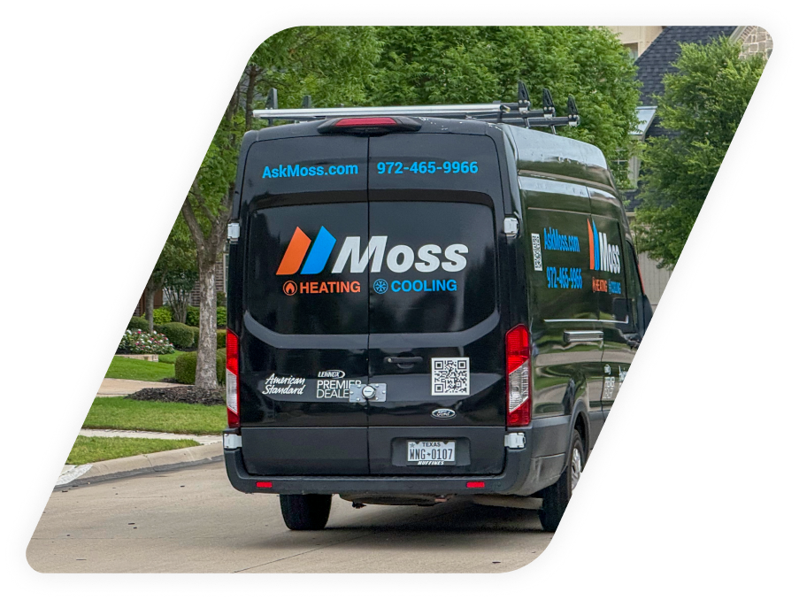Rear view of a Moss Heating & Cooling service van with logo and contact info on a suburban street.