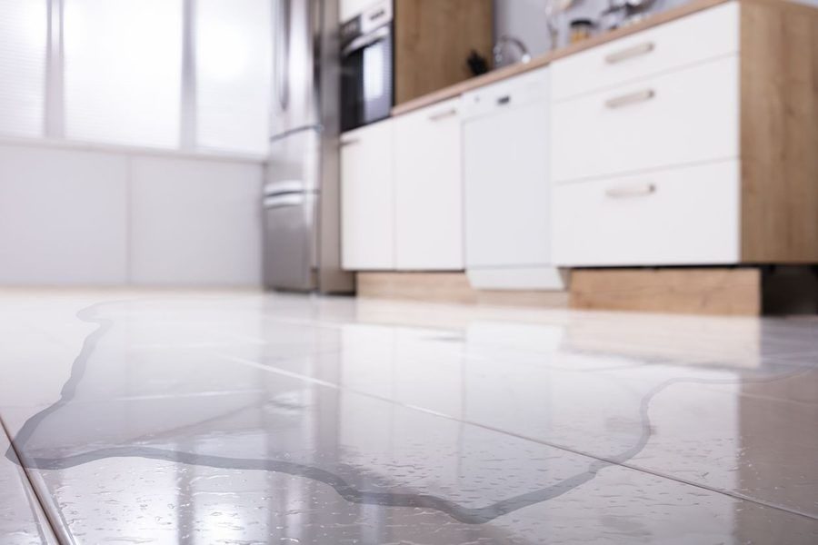 water pooling on the floor of a kitchen