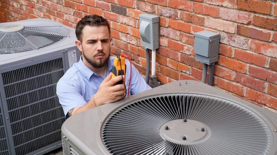 Moss technician performing a maintenance check on an AC